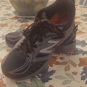 New Balance Black and Gray Athletic Shoes with Orange Highlights